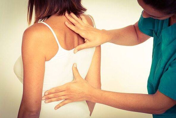 Doctor examining back with thoracic osteochondrosis